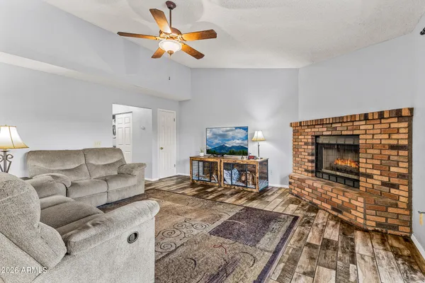 a living room with furniture a fireplace and a flat screen tv