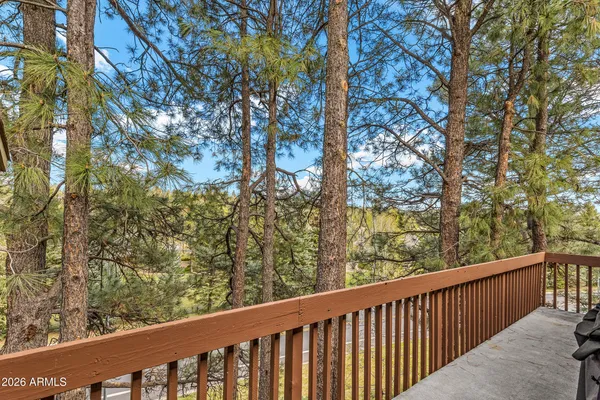 a view of a balcony with wooden fence and floor