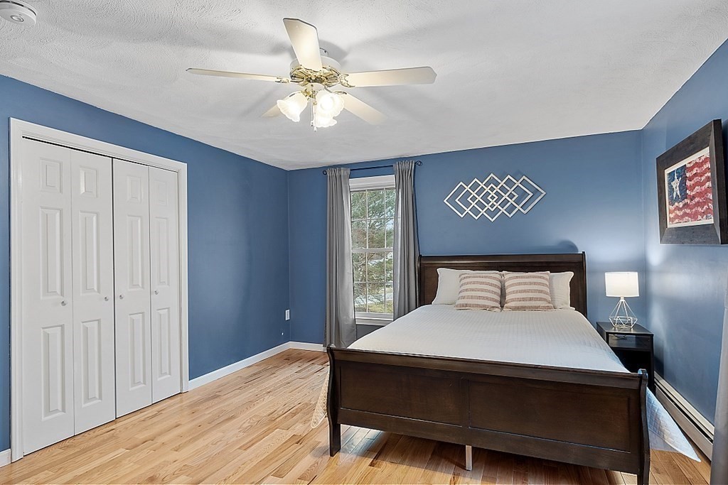 7 Gavin Circle Andover, MA 01810 - Photo 26 of 42 a bedroom with a bed and a chandelier