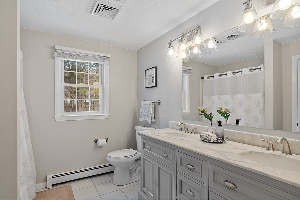 7 Gavin Circle Andover, MA 01810 - Photo 27 of 42 a bathroom with a granite countertop sink a toilet and a mirror