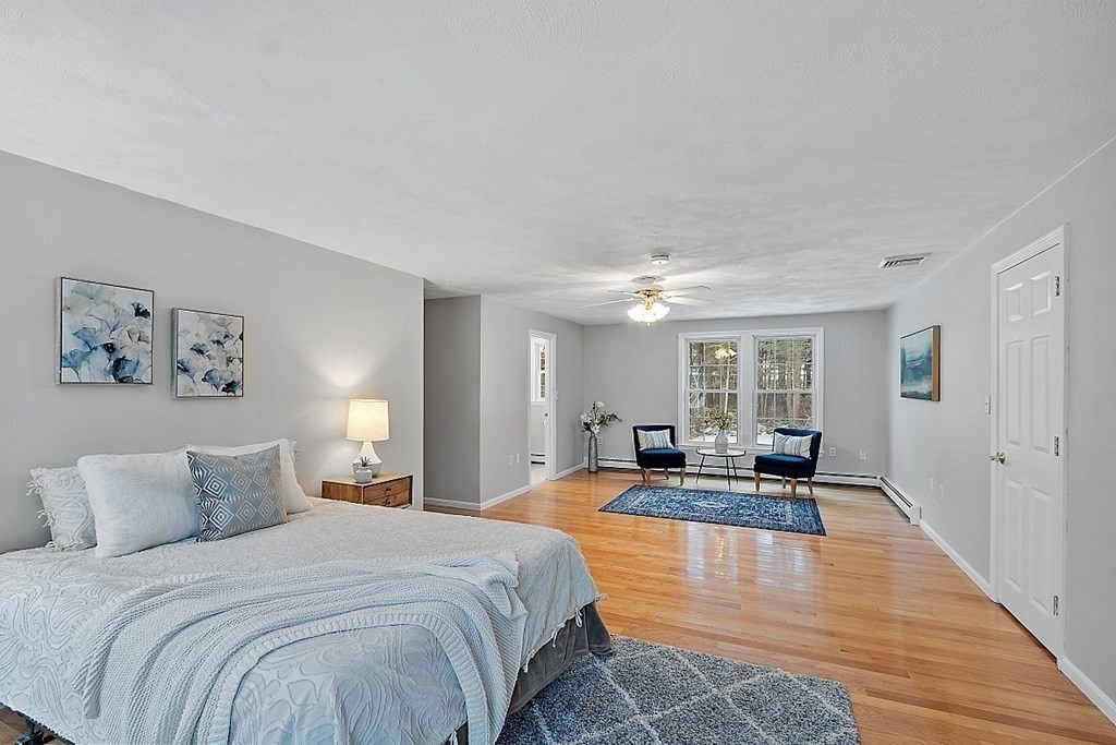 7 Gavin Circle Andover, MA 01810 - Photo 28 of 42 a spacious bedroom with a bed a couch and large windows