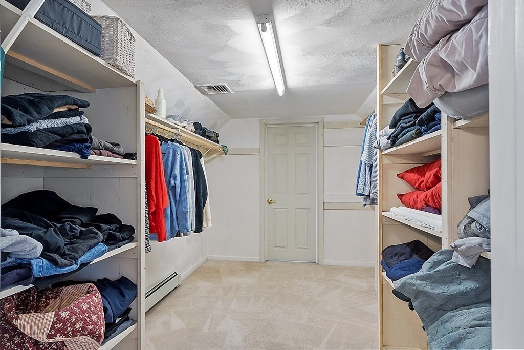 7 Gavin Circle Andover, MA 01810 - Photo 31 of 42 a view of walk in closet with clothes and shoes