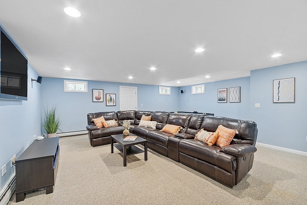 7 Gavin Circle Andover, MA 01810 - Photo 35 of 42 a living room with furniture and a flat screen tv