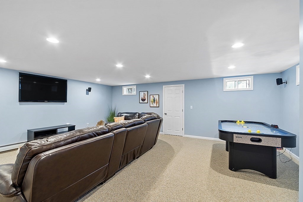 7 Gavin Circle Andover, MA 01810 - Photo 37 of 42 a living room with stainless steel appliances kitchen island furniture and a flat screen tv