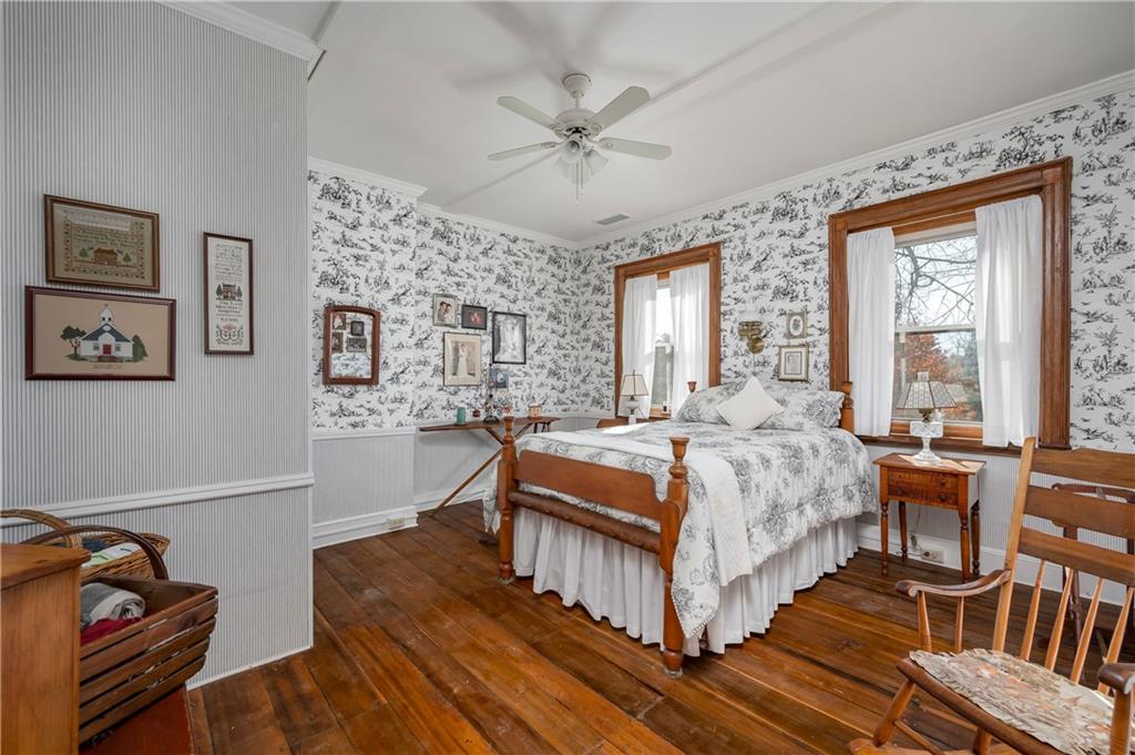 957 Butler Pike Mercer, PA 16137 - Photo 11 of 25 a bedroom with a bed and a chandelier
