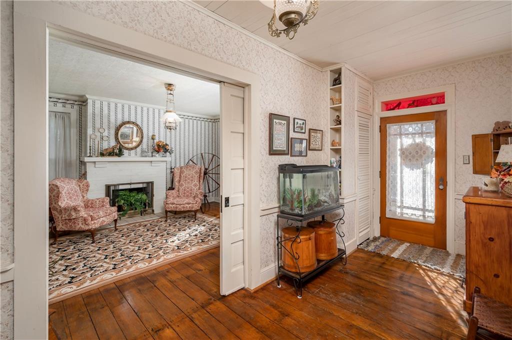 957 Butler Pike Mercer, PA 16137 - Photo 3 of 25 a room with fireplace and wooden floor