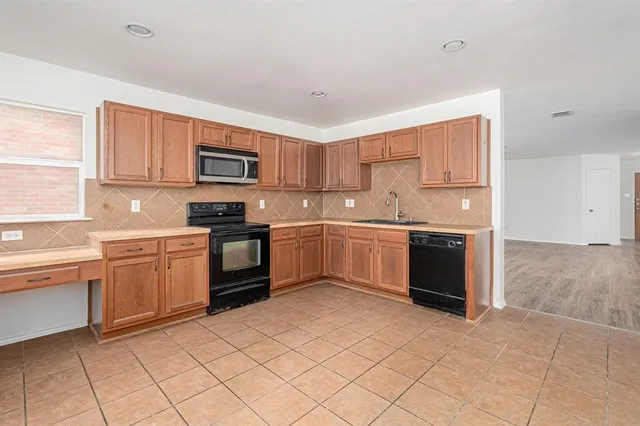 a kitchen with a sink and a stove top oven