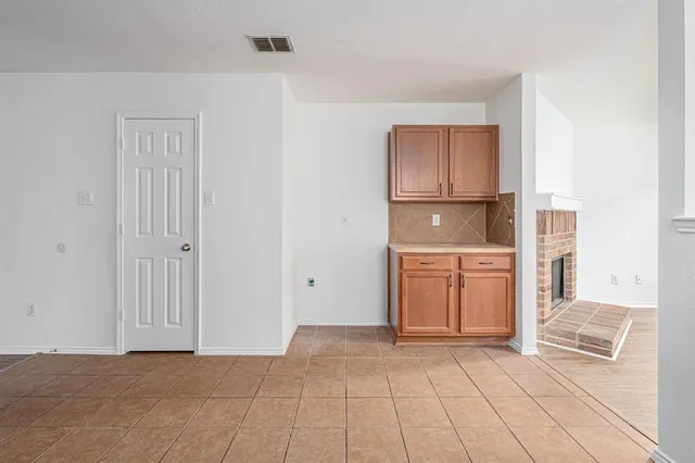 a view of a kitchen with a sink and a refrigerator