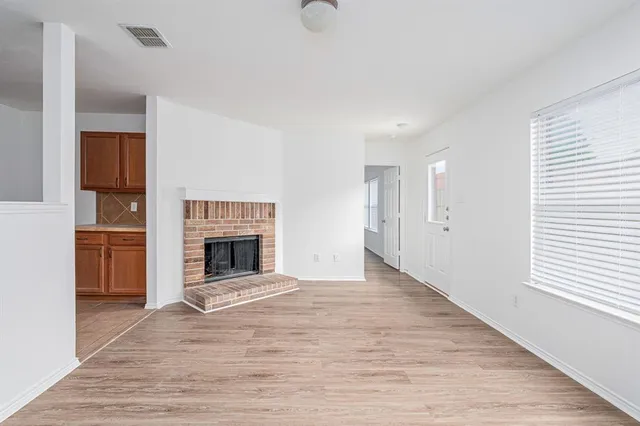 a view of a livingroom with an empty space and a fireplace