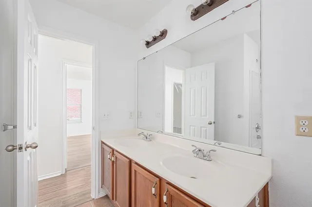 a bathroom with a sink double vanity and a mirror