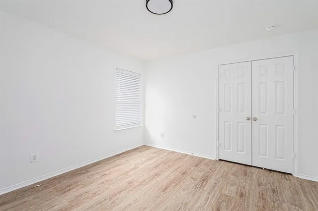 a view of a room with wooden floor and glass window