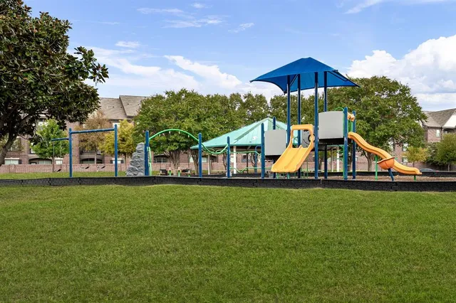 a view of a house with a yard and sitting area