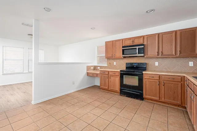 a kitchen with a sink cabinets and stainless steel appliances
