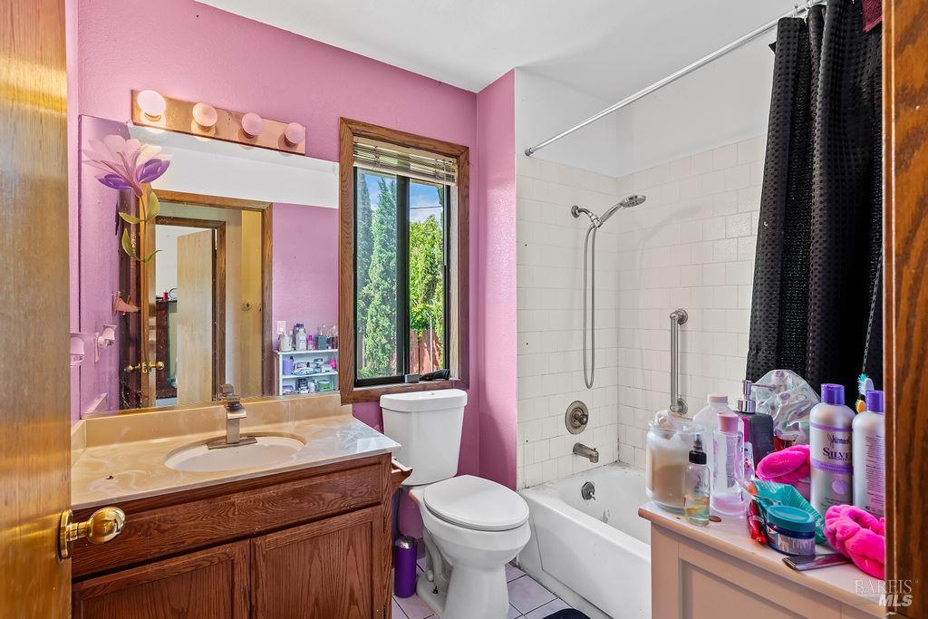715 Placer Court Santa Rosa, CA 95401 - Photo 21 of 37 a bathroom with a sink vanity mirror and toilet