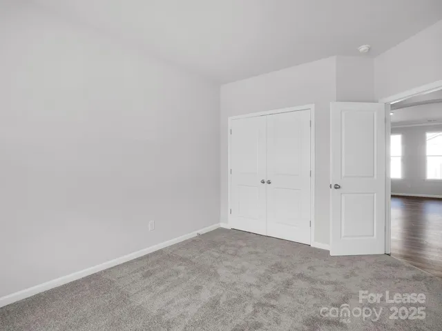 a view of an empty room and closet area