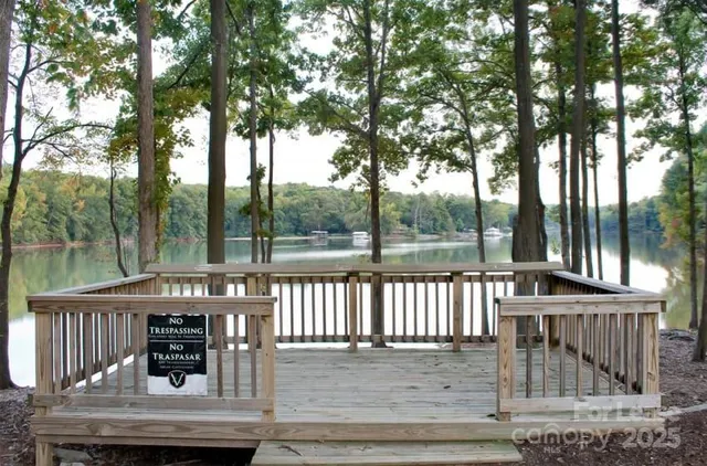 a view of a roof deck with wooden floor and fence