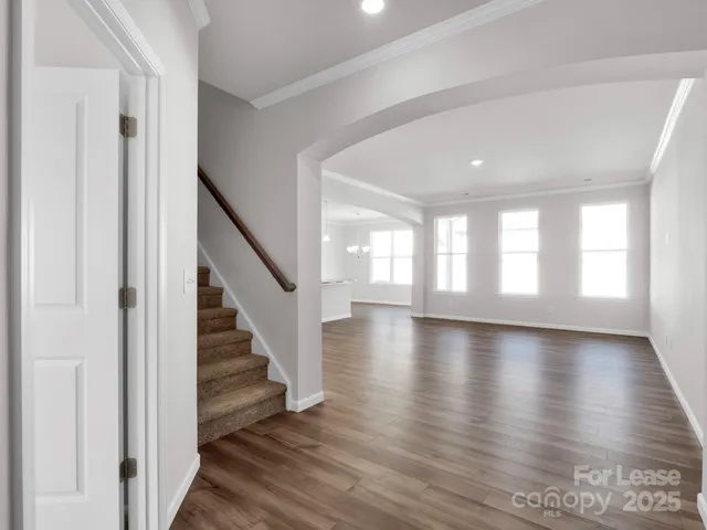 a view of an entryway with wooden floor