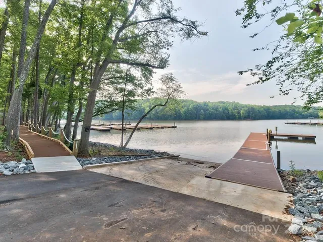 a view of a house with backyard fountain and sitting area