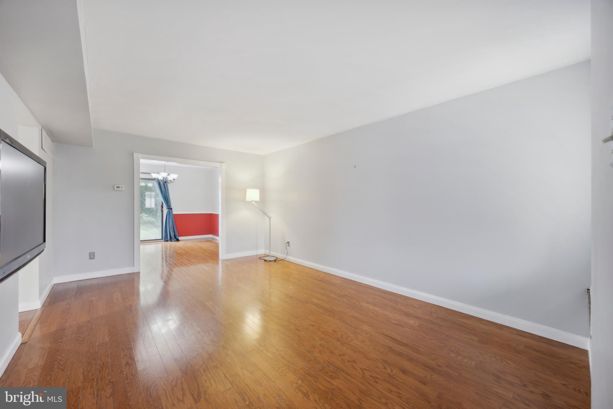 105 Grant Road Lansdale, PA 19446 - Photo 2 of 15 a view of an empty room with wooden floor and a window
