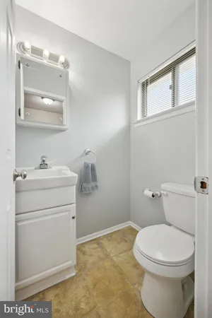 a bathroom with a sink toilet and mirror