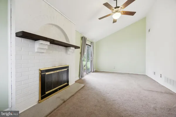 a view of empty room with fireplace