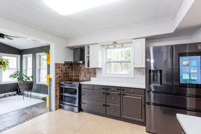 a kitchen with a sink stainless steel appliances and cabinets