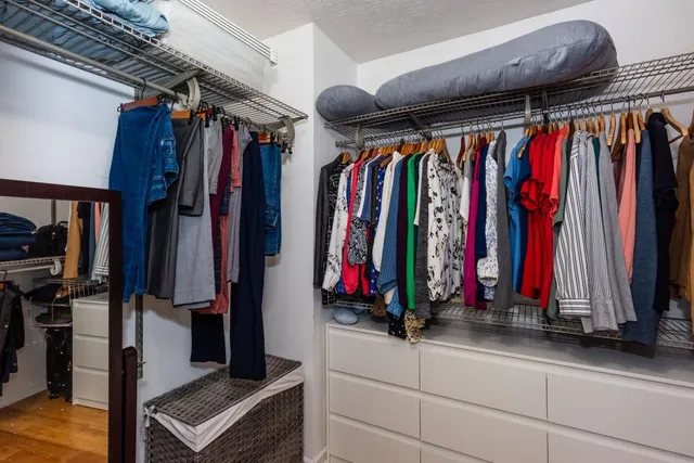 a bedroom with a large bed and a chandelier fan
