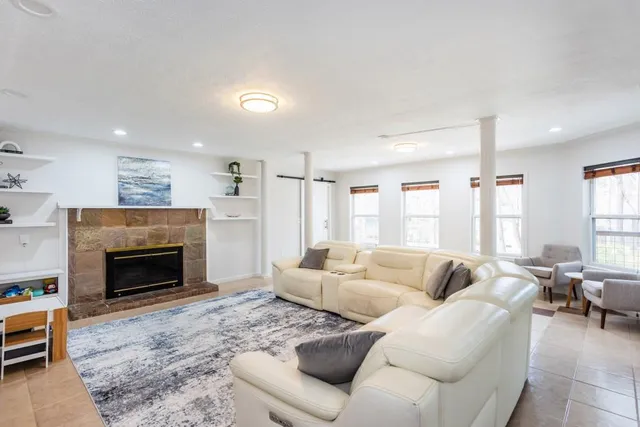 a living room with furniture and a fireplace