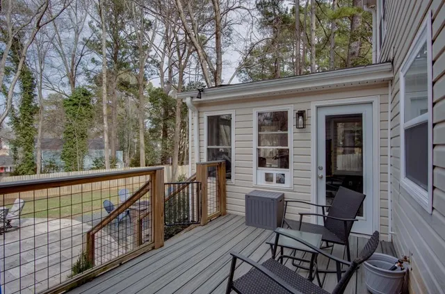 a view of balcony with two chairs and wooden floor