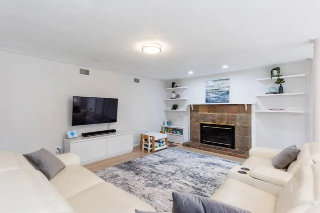 a living room with furniture and a fireplace