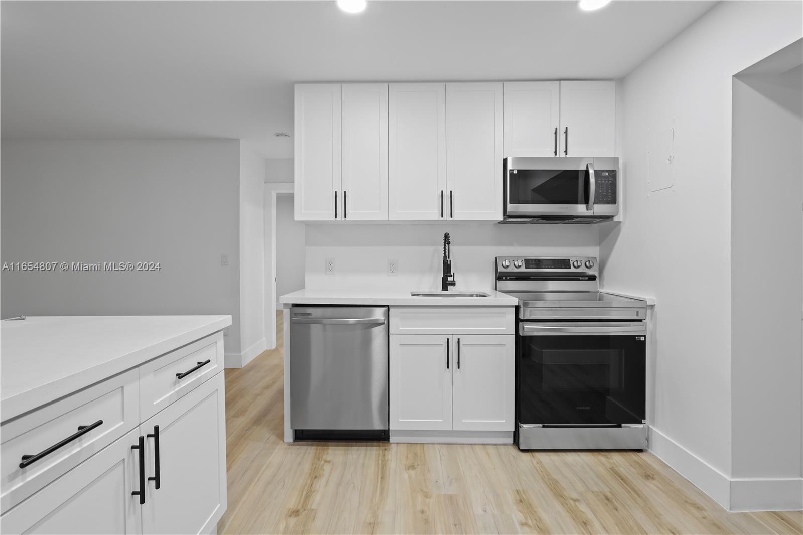 29010 Louisiana Road Homestead, FL 33033 - Photo 2 of 16 a kitchen with white cabinets stainless steel appliances and sink