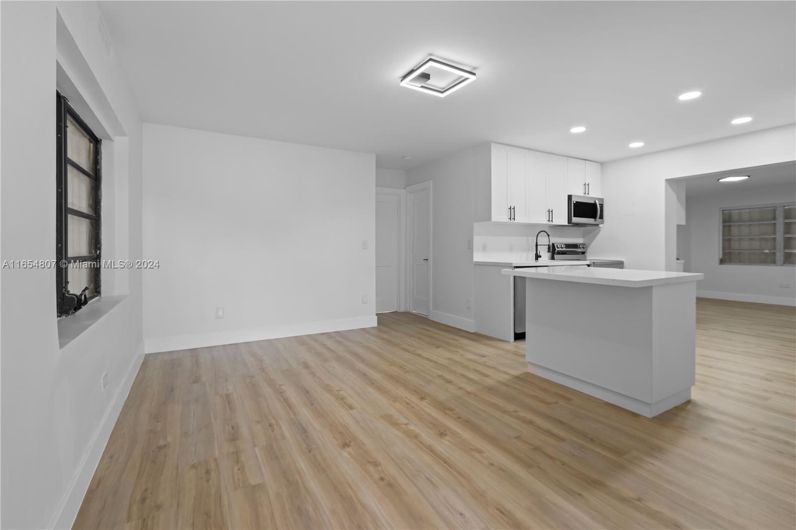 29010 Louisiana Road Homestead, FL 33033 - Photo 3 of 16 a view of a kitchen with wooden floor and windows