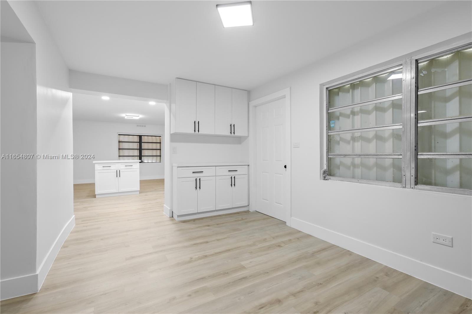 29010 Louisiana Road Homestead, FL 33033 - Photo 5 of 16 a view of kitchen with white wooden cabinets and white appliances