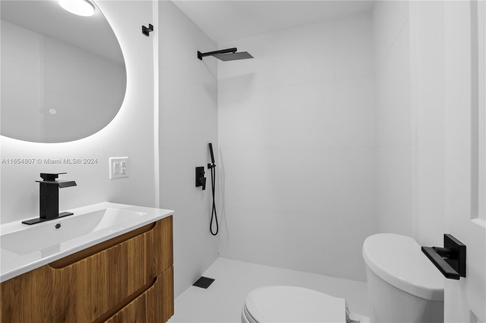 29010 Louisiana Road Homestead, FL 33033 - Photo 7 of 16 a bathroom with a toilet sink and mirror