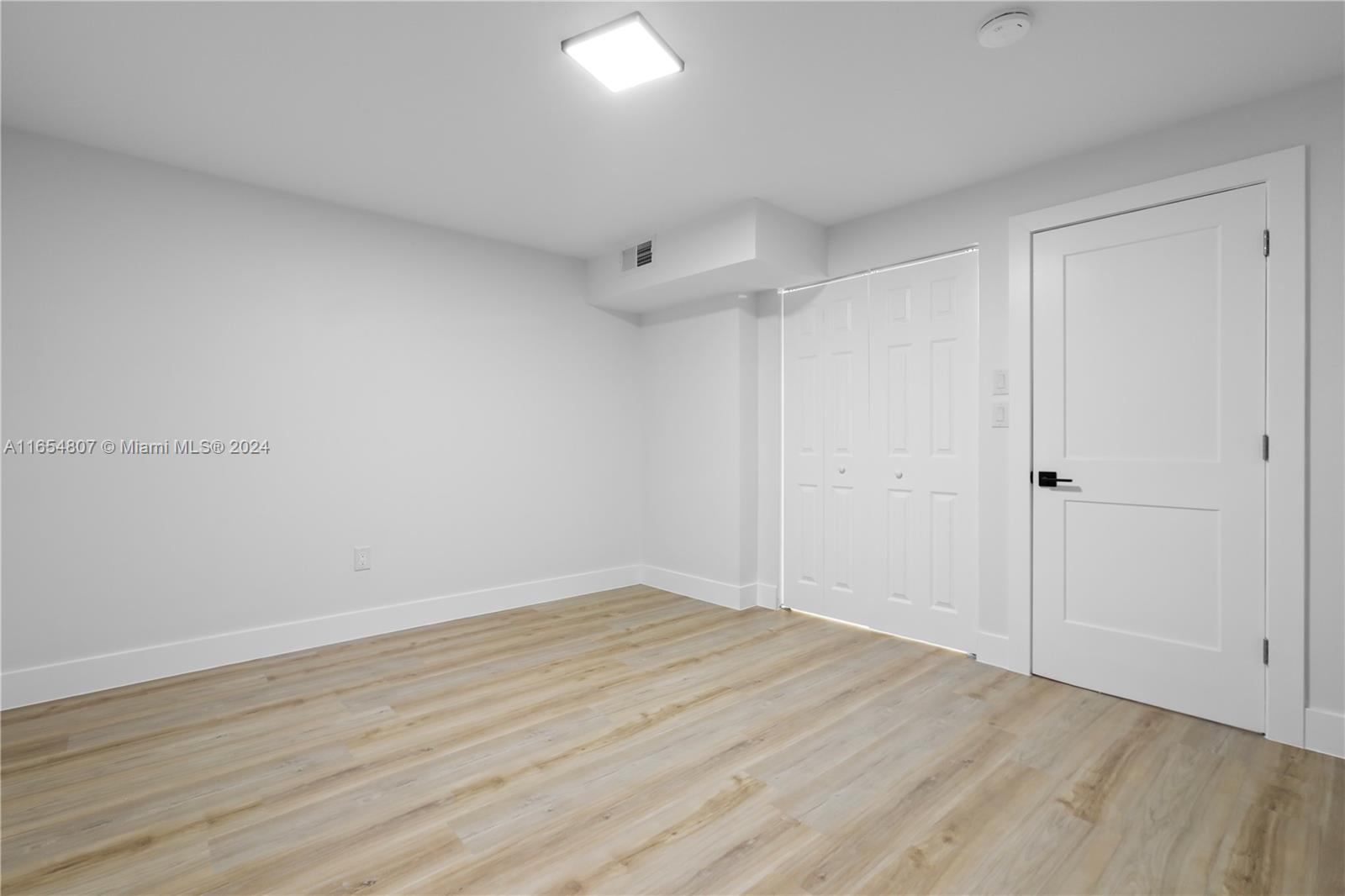 29010 Louisiana Road Homestead, FL 33033 - Photo 8 of 16 wooden floor in an empty room