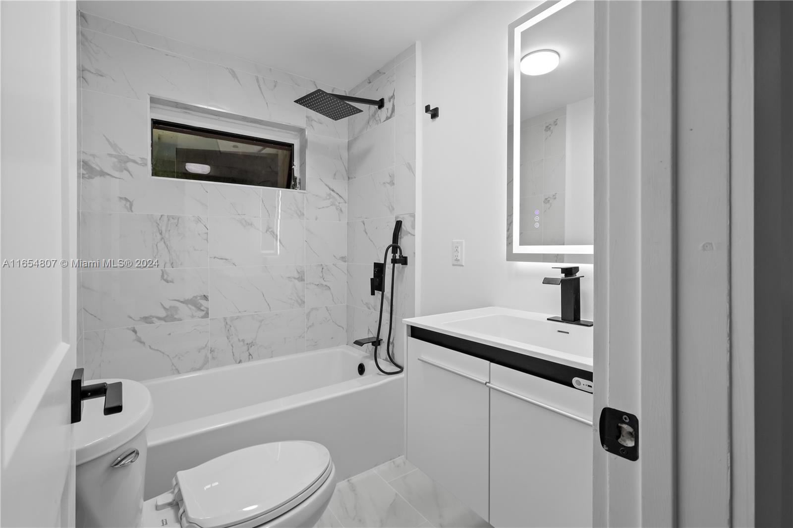 29010 Louisiana Road Homestead, FL 33033 - Photo 10 of 16 a bathroom with a granite countertop sink toilet and shower