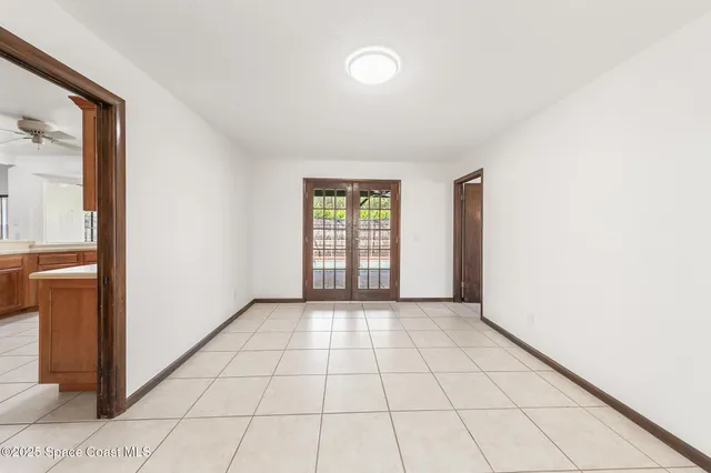 a view of an empty room with a fireplace and a window