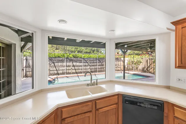 a view of washer and dryer with wooden cabinets