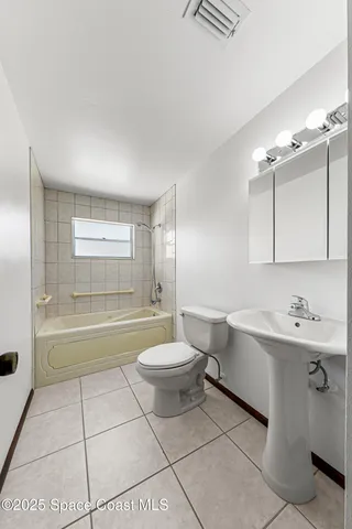 a backyard of a house with plants and wooden fence