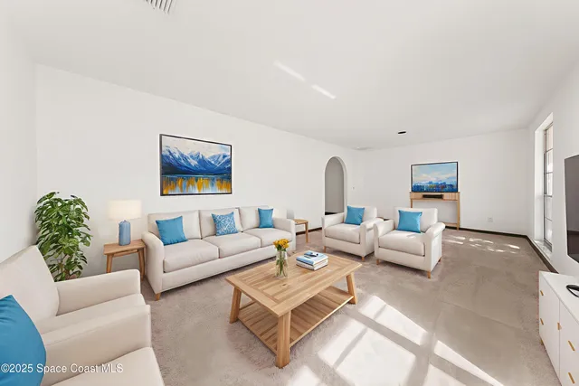 a bedroom with a large bed and a potted plant