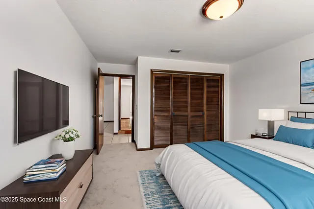 a bedroom with a large bed and a window