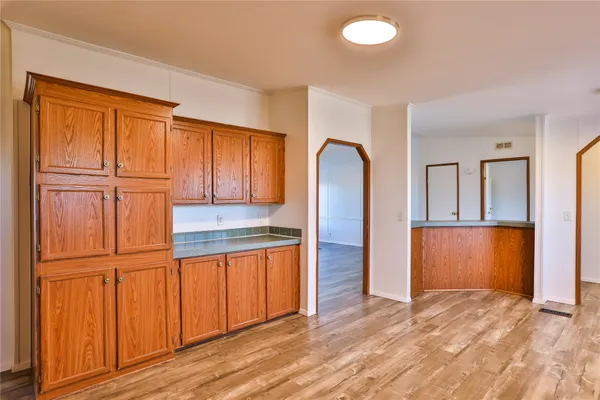 a kitchen with stainless steel appliances granite countertop a refrigerator a sink and a dishwasher
