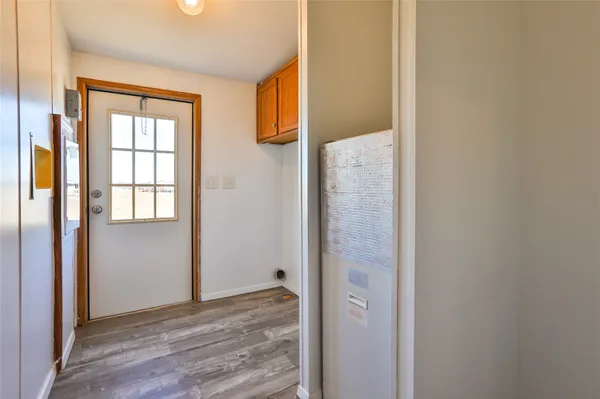 a view of a bathroom with wooden floor and windows