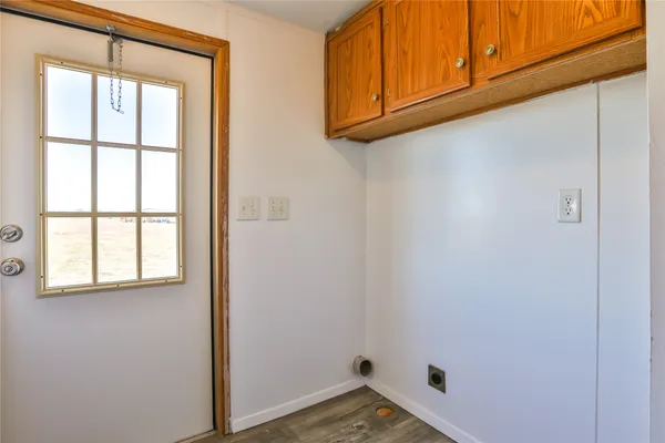 a small space with wooden floor and a window