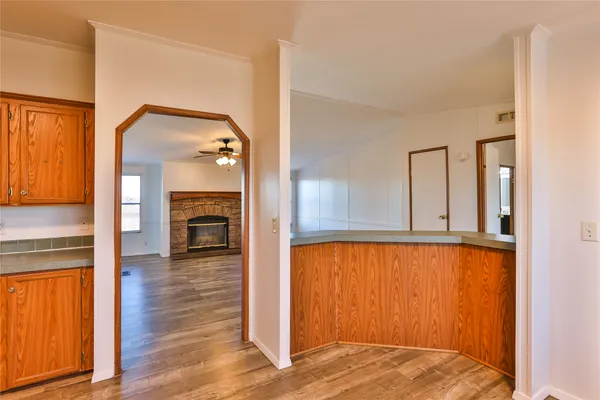 a view of a livingroom with wooden floor and staircase
