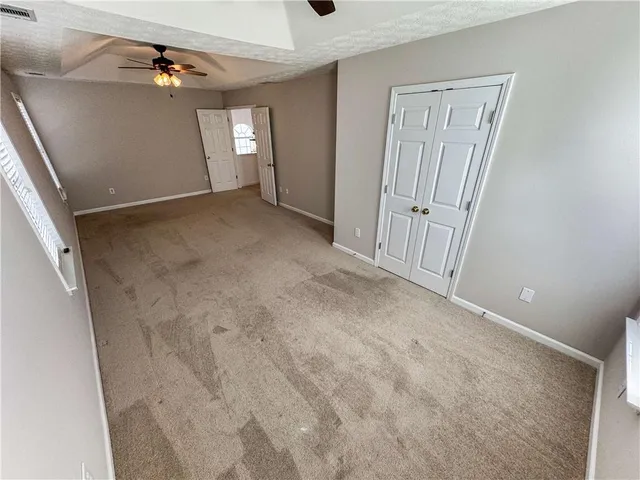 a bathroom with a tub a sink and a large mirror