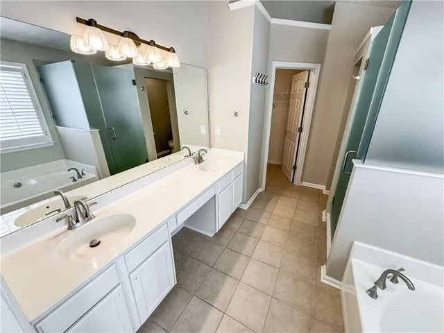 a bathroom with a tub and shower