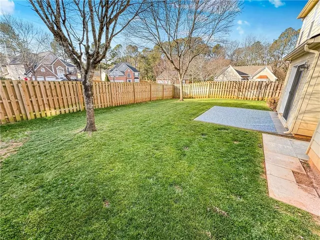 a view of a backyard with a large tree