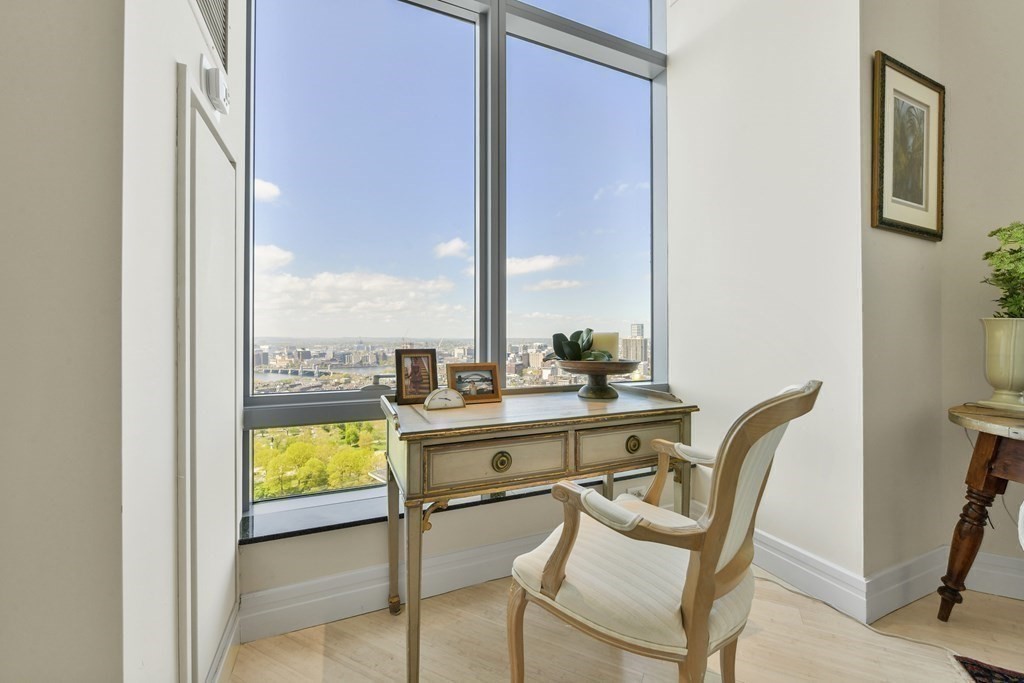 1 Avery Street, Unit PH1A Boston, MA 02111 - Photo 11 of 29 a view of a dining room with chairs a rug and wooden floor