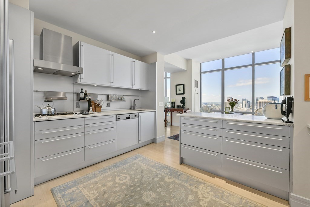 1 Avery Street, Unit PH1A Boston, MA 02111 - Photo 17 of 29 a kitchen with white cabinets and white appliances